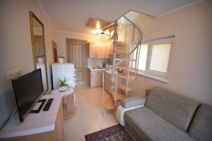 a small living room with a couch and a television at Ramybes sala in Palanga