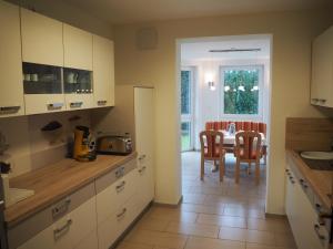 a kitchen with a table and a dining room at Ferienwohnung Künzell in Künzell