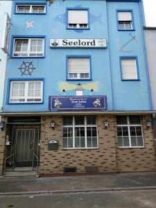 a blue building with a scientologist sign on it at See Lord Hotel in Kaiserslautern