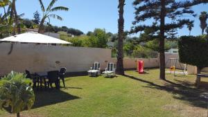 a yard with a table and chairs and a wall at Villa Gallina in Avola