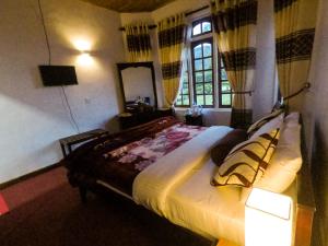 Giường trong phòng chung tại Nuwara Eliya Hills Rest