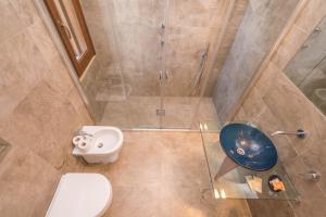 a bathroom with a shower and a toilet and a sink at B&B Le Dune - Self Check in in Lascari