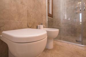a bathroom with a toilet and a shower at B&B Le Dune - Self Check in in Lascari
