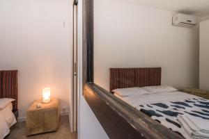a bedroom with a bed and a candle on a table at B&B Le Dune - Self Check in in Lascari