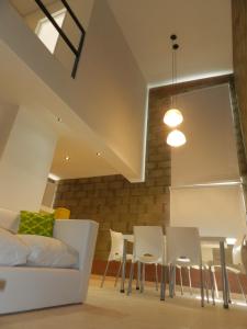 a living room with a couch and a table and chairs at Alta Patagonia Apart in Viedma