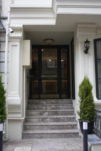 a front door of a white house with stairs at Endless Comfort Hotel Taksim in Istanbul