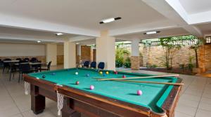 a pool table with cue balls on top of it at Natal Praia Hotel in Natal +68 photos