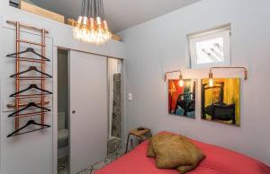 a bedroom with a red bed and a chandelier at Unique Studio House | City Centre in Lisbon +3 photos