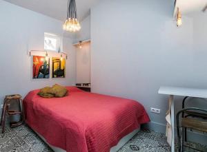 a bedroom with a red bed and a mirror at Unique Studio House | City Centre in Lisbon