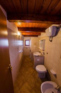 a bathroom with a toilet and a sink at Il Rudere in Gonnesa