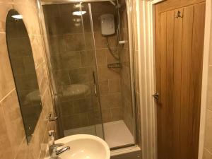 a bathroom with a shower and a sink and a shower at White Horse Tavern in Telford