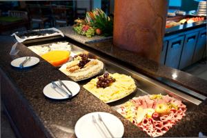 a buffet line with several different types of food at Natal Praia Hotel in Natal