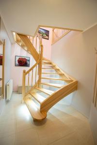 a staircase in a house with wooden railings at Apartament Luna in Giżycko