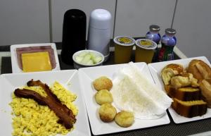 a table with two plates of breakfast foods and drinks at Apple Motel ( Adults Only ) in Sao Paulo