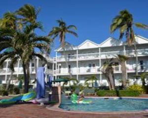 a resort with a swimming pool in front of a building at Coconut Beach Resort in Key West
