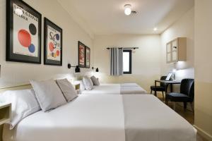 Postel nebo postele na pokoji v ubytování Hotel El Call