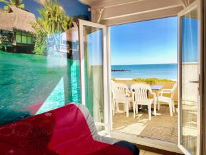 a living room with a view of the ocean at Barcaresa-Charmant T 2 vue mer pied dans l'eau in Le Barcarès