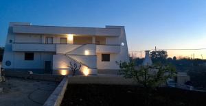 a white house with lights in front of it at Terrazza Sui Colli in Monopoli