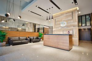 a lobby with leather chairs and a reception desk at Ameri Apartments Tbilisi in Tbilisi City