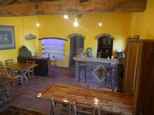 a restaurant with a bar and some tables and chairs at B&B Sa Tuerra in Teulada