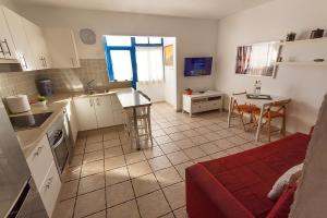 a kitchen and living room with a table and chairs at Casa Maralba Famara in Famara
