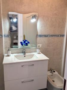 a bathroom with a sink and a mirror and a toilet at Ocean View Apartment in Palm-mar +42 photos