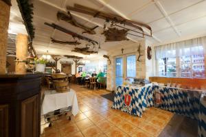 a restaurant with a counter and a table in a room at Hotel Forsthaus Sellin in Ostseebad Sellin