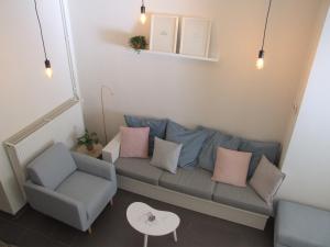 a living room with a couch and a chair at Maison HB in Ieper