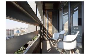 a balcony with two white chairs on a building at Urban sky studio @ Hallmark House in Johannesburg