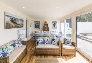 a living room with a table and chairs at Beachside Apartment, 2 Pilots Point in Totland