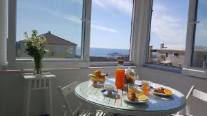 a table with breakfast food on it in front of a window at Lari Home in Primošten