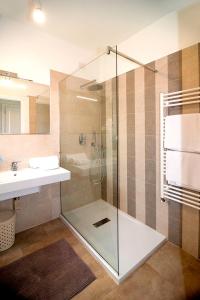 a bathroom with a glass shower and a sink at Stella Marina Budoni in Budoni