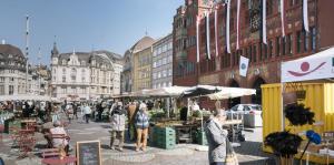 a group of people walking around a market in a city at Schönes Zimmer in der City Basel in Basel