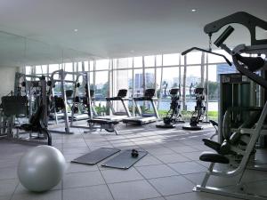 a gym with a lot of treadmills and machines at Grand Beach Hotel Bay Harbor in Miami Beach