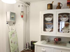 a kitchen with a cabinet with dishes in it at Casa di Fol in Kalabaka