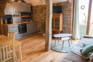 un soggiorno con tavolo e cucina di A la Grange d'en Haut a Bras-Haut