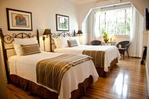 Rúm í herbergi á Grano de Oro Hotel