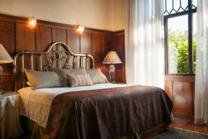 Rúm í herbergi á Grano de Oro Hotel