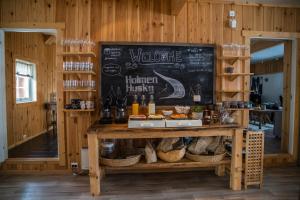 a restaurant with a counter with a chalkboard at Holmen Husky Lodge in Alta