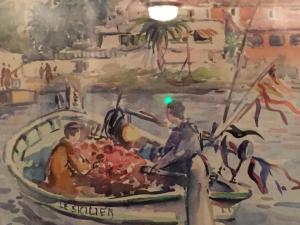 a painting of a man in a boat at Hôtel Le Porquerollais in Porquerolles