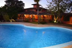 a large swimming pool in front of a house at Pousada Kailani in Búzios