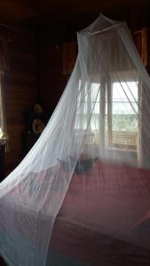A bed or beds in a room at Sunset Guest House & Bar