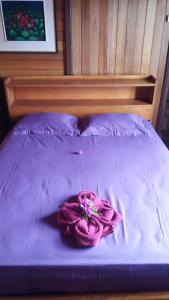 A bed or beds in a room at Sunset Guest House & Bar