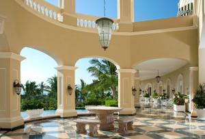 a lobby of a resort with a table and chairs at Pueblo Bonito Emerald Bay Resort & Spa - All Inclusive in Mazatlán