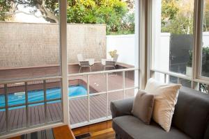 a living room with a couch and a swimming pool at Brighton House in Melbourne