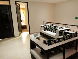 a living room with two beds and a couch at Hotel Dulces Sueños in Santa Rosa de Cabal