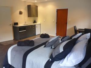 um quarto com uma cama grande com almofadas em GMH Home Stay em Blenheim