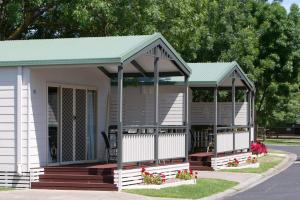 una pequeña casa blanca con techo verde en BIG4 Mornington Peninsula Holiday Park en Frankston