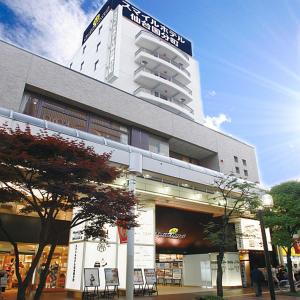 a large building with a clock on the front of it at Smile Hotel Sendai-Kokubuncho in Sendai