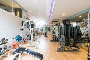 a gym with a bunch of equipment in a room at Evergreen Place Siam by UHG - SHA Extra Plus in Bangkok